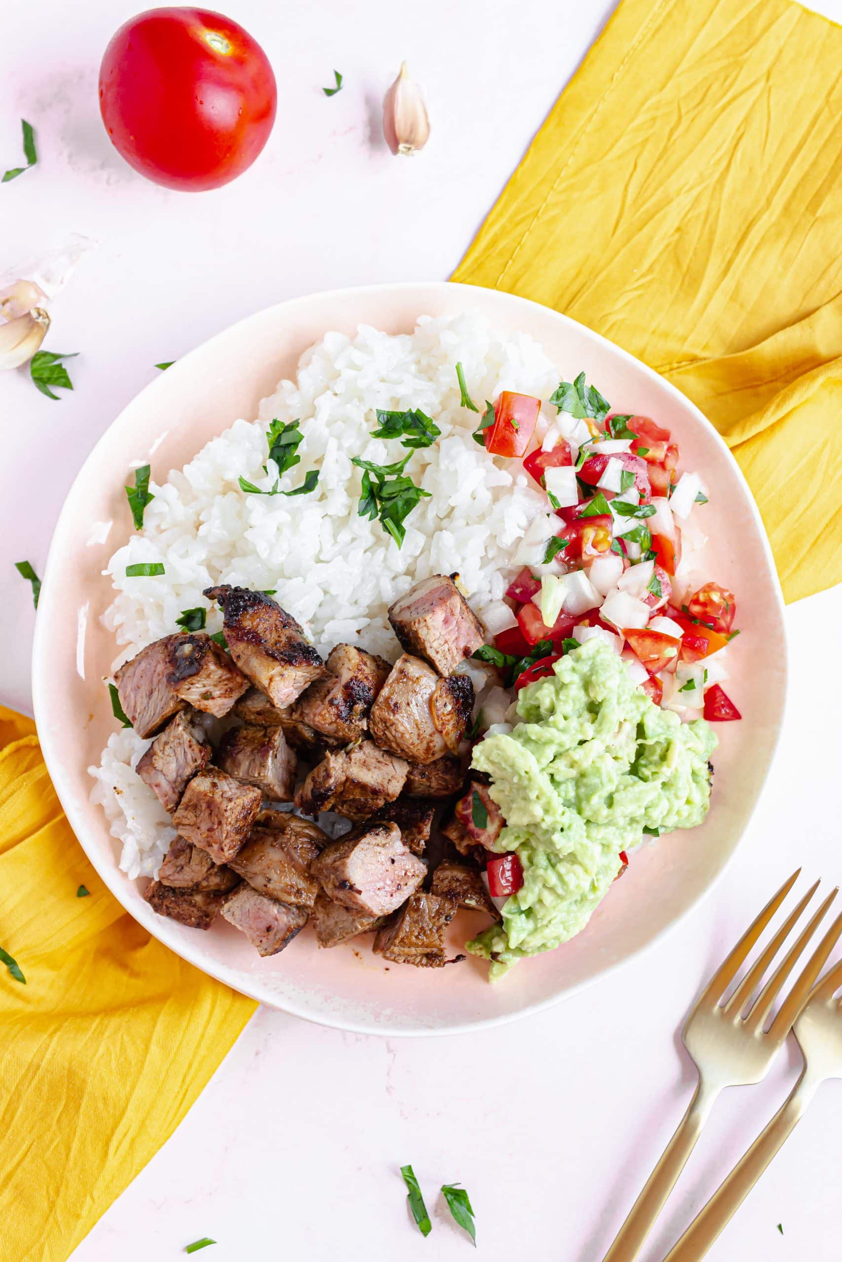 homemade chipotle steak strips next to white rice in a white bowl