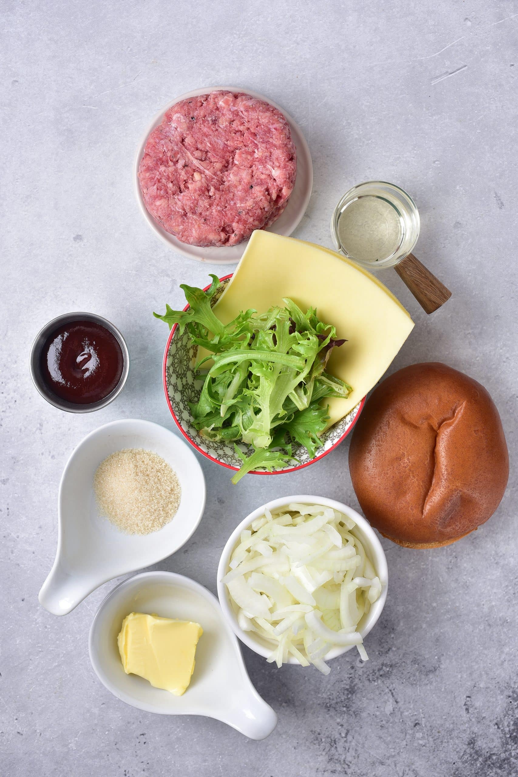 an overhead image showing the measured ingredients needed to make a batch of air fryer burgers with toppings