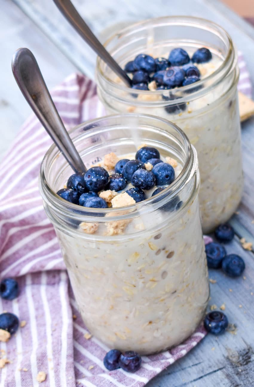blueberry cheesecake overnight oats in two small glass jars