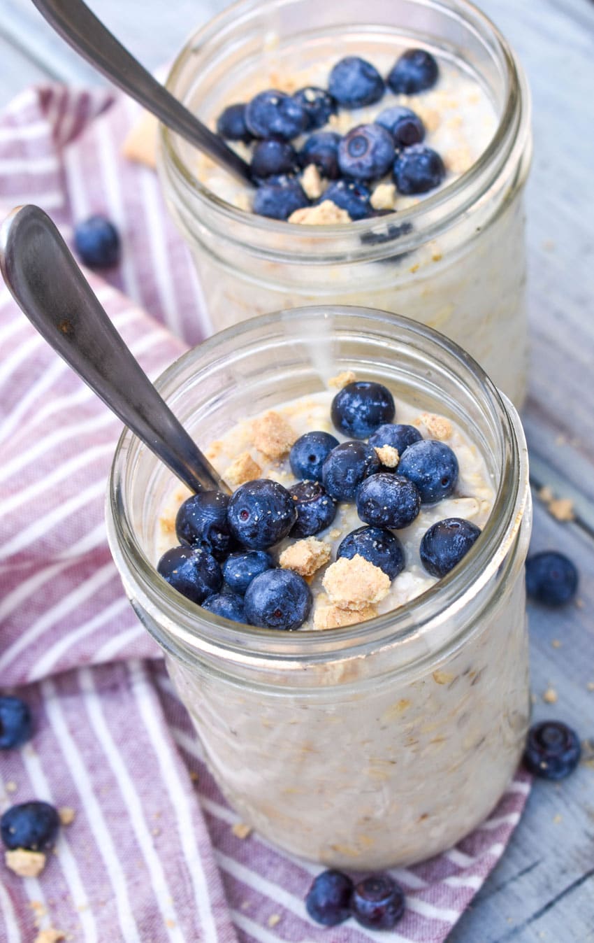 blueberry cheesecake overnight oats in two small glass jars