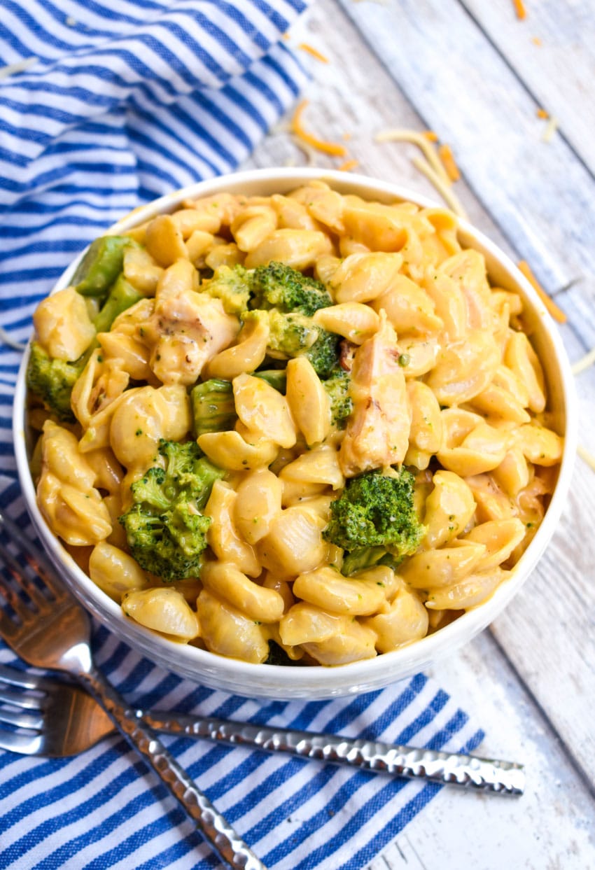 cheesy chicken and broccoli macaroni and cheese in a white bowl