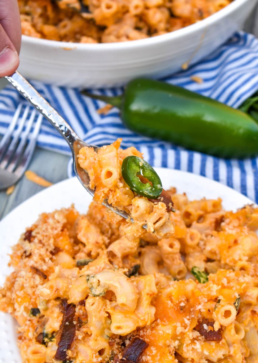 a silver fork lifting up a bite of jalapeno popper mac and cheese