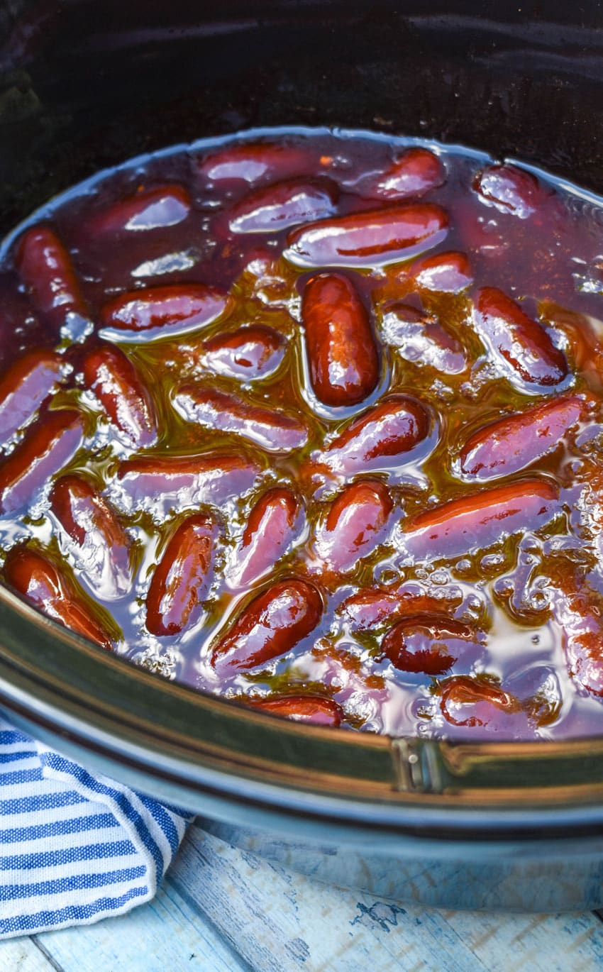 slow cooker little smokies in the black bowl of a crockpot