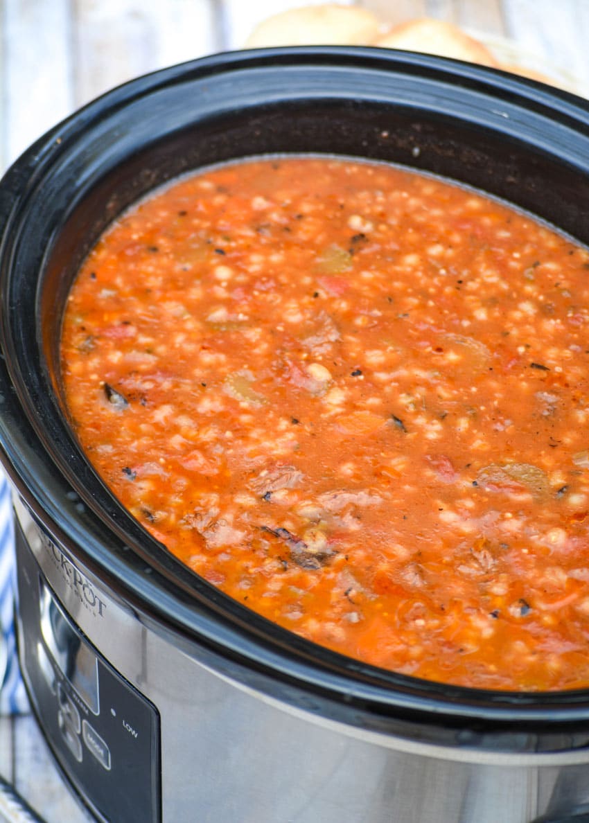 tomato soup with beef and barley in a black crockpot