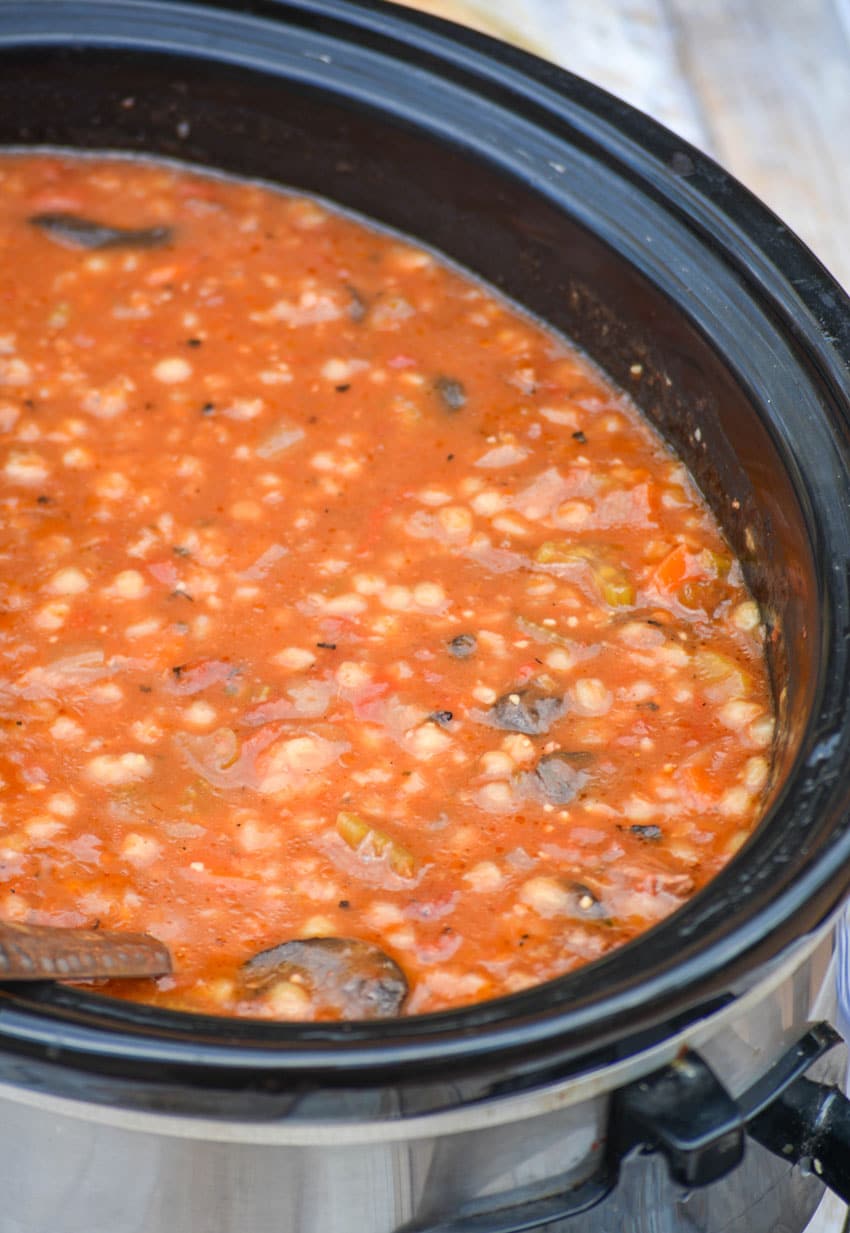 tomato soup with beef and barley in a black crockpot