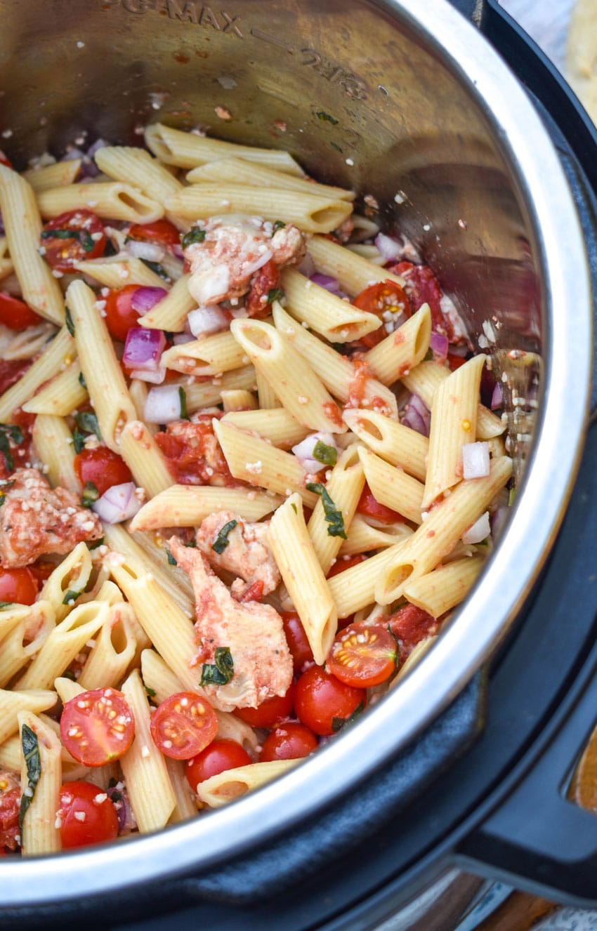 bruschetta chicken and pasta in the bowl of an instant pot