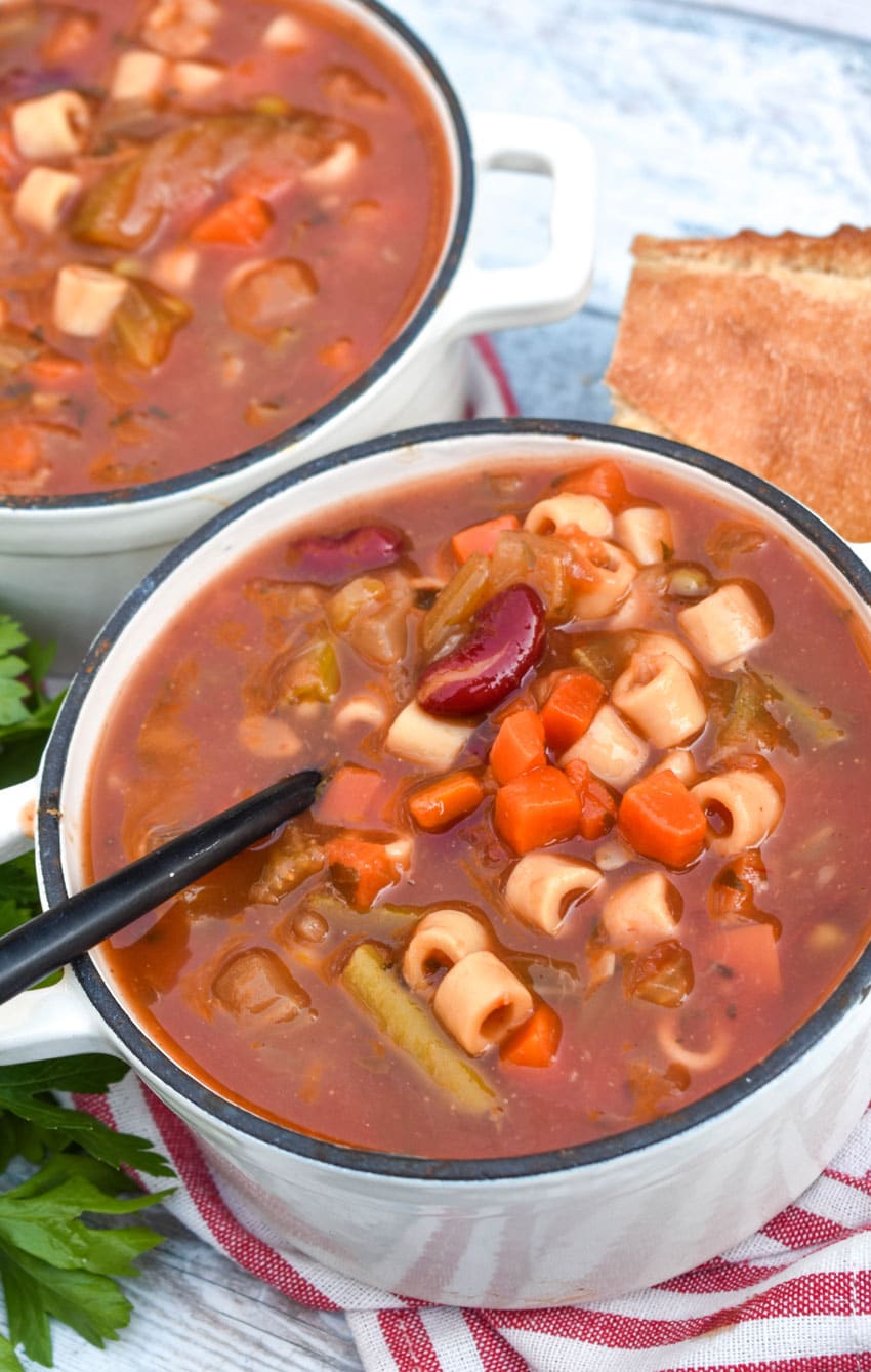 Italian vegetable minestrone soup in two small cast iron bowls