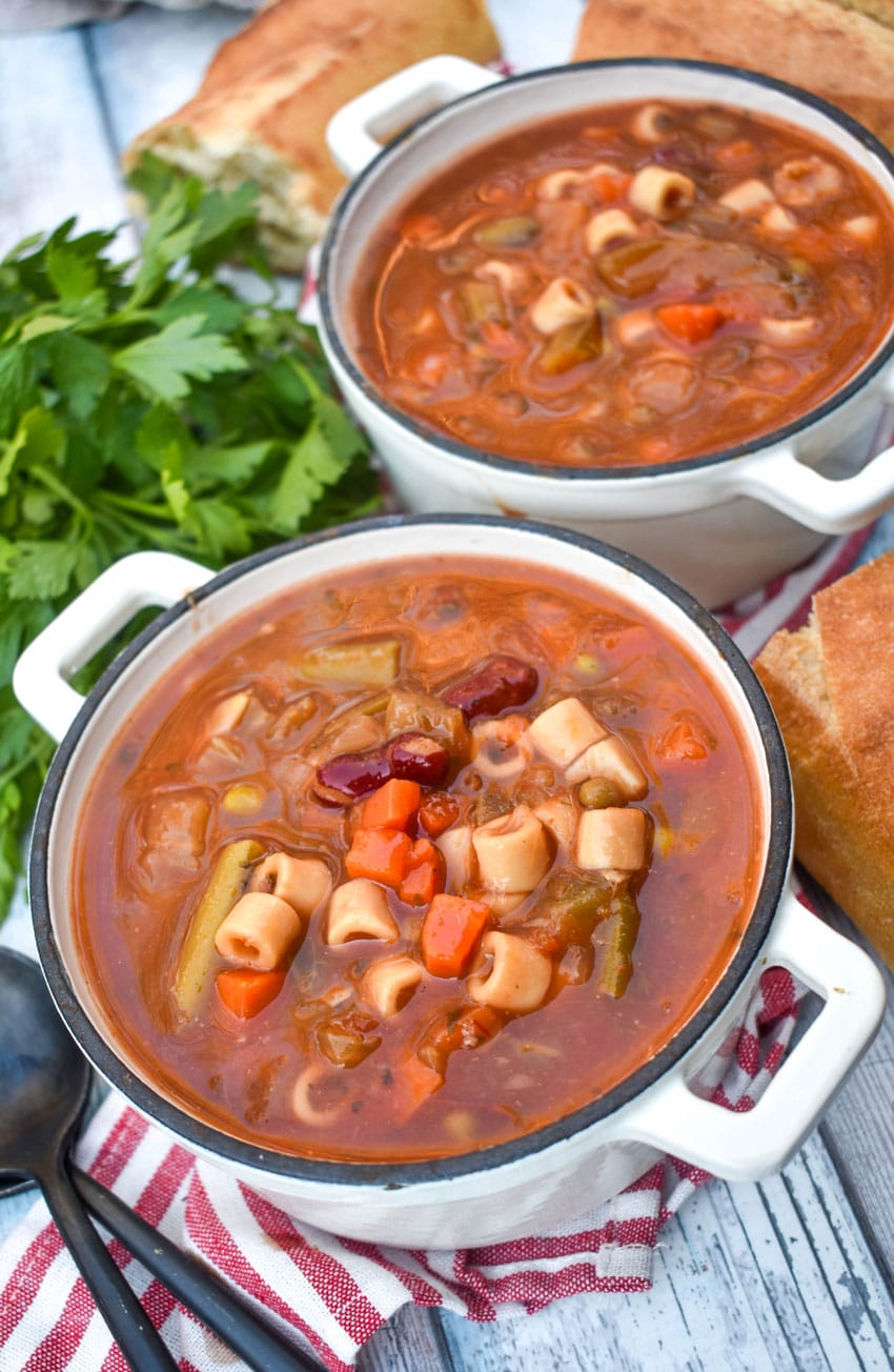 Italian vegetable minestrone soup in two small cast iron bowls