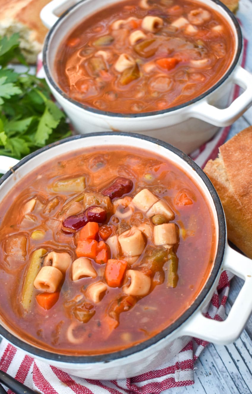 Italian vegetable minestrone soup in two small cast iron bowls