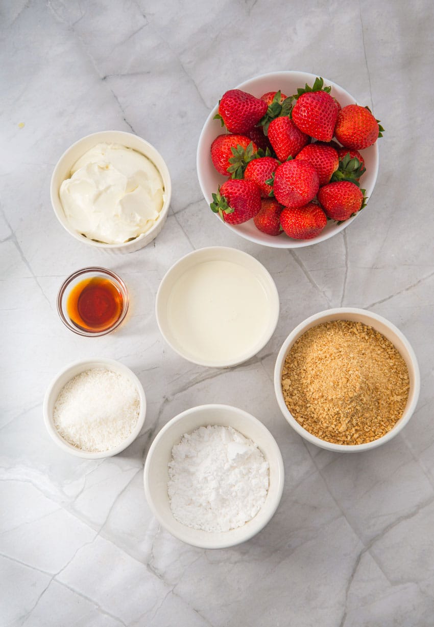 an overhead image showing the measured ingredients needed to make strawberry cheesecake cups