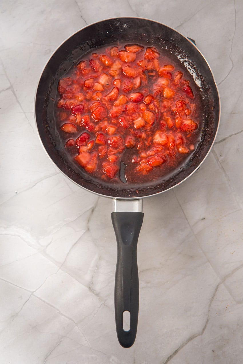 homemade strawberry filling in a small black skillet