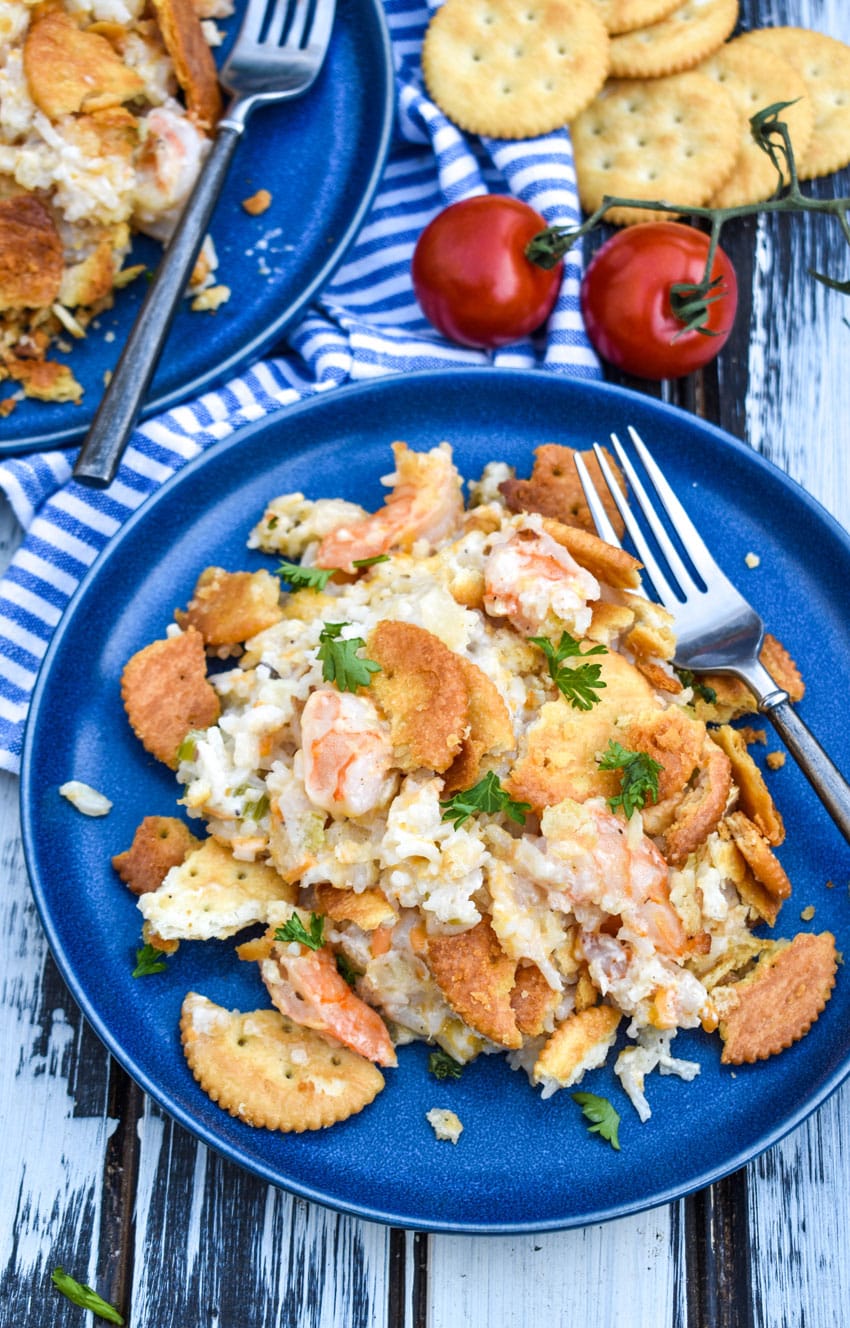 shrimp and rice casserole on a small blue plate with a fork resting on the side