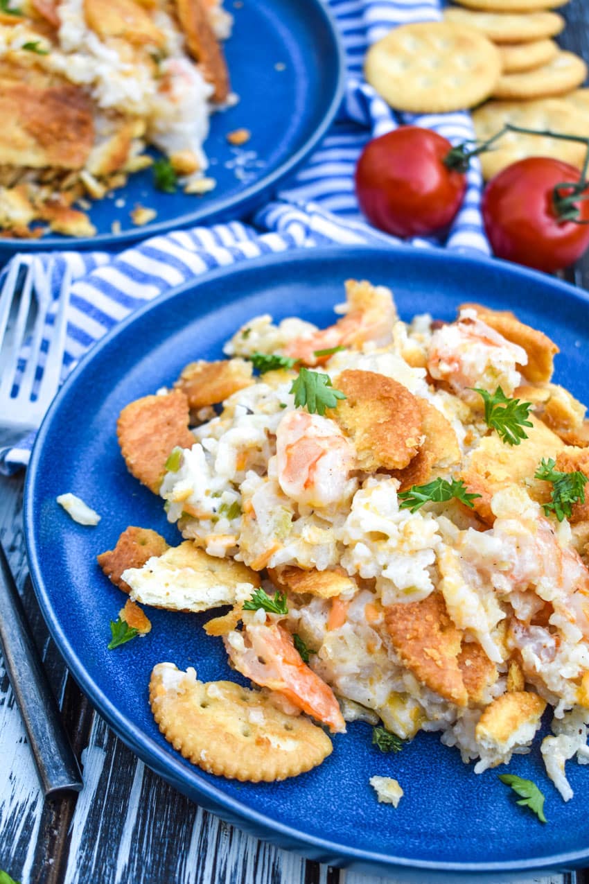 shrimp and rice casserole on a small blue plate with a fork resting on the side