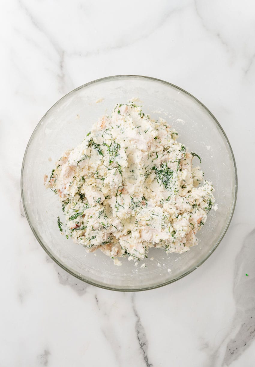 white chicken lasagna filling in a glass mixing bowl