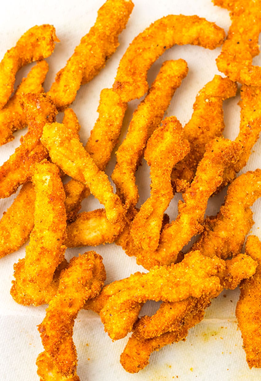 fried chicken strips laying on a layer of paper towels