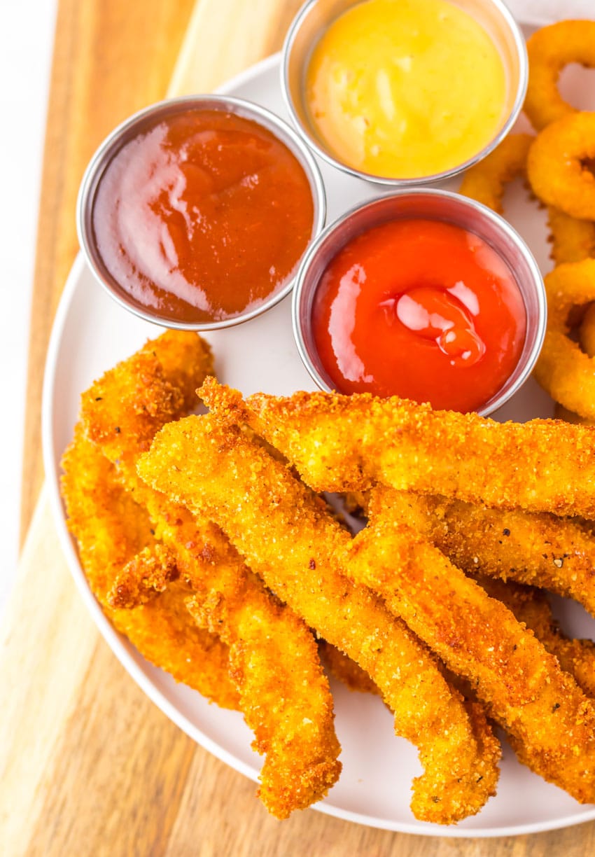 a closeup of homemade chicken fries on a white plate