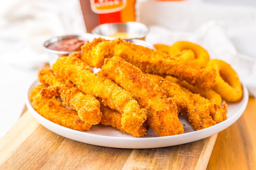 a closeup of homemade chicken fries on a white plate