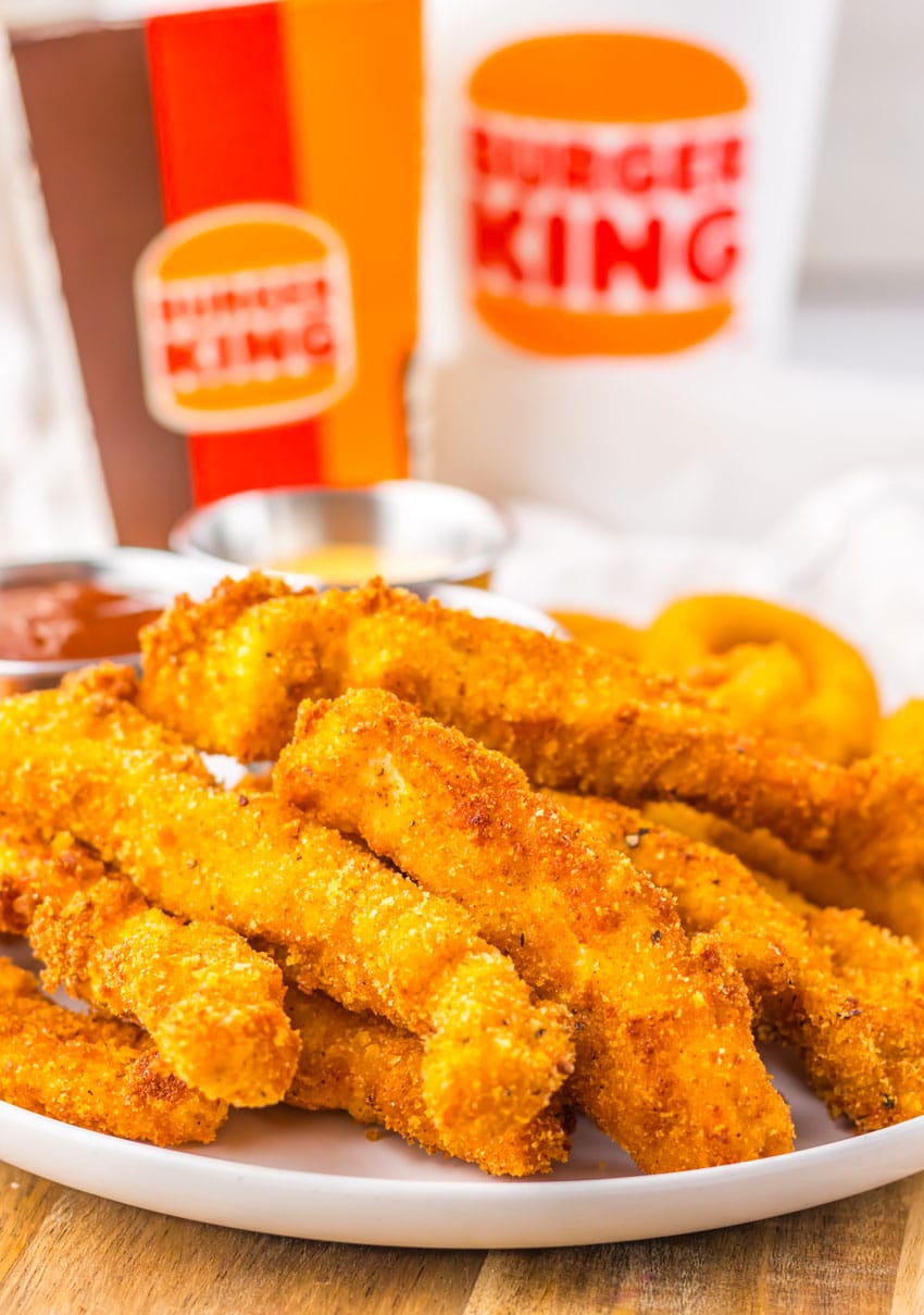 homemade chicken fries piled on a white plate