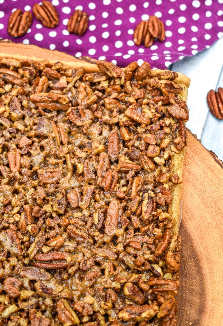 homemade pecan pie bars on a wooden cutting board