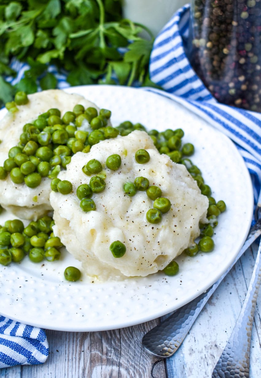 homemade peas and dumplings on a small white plate