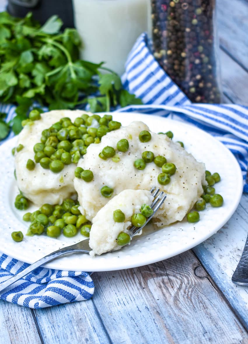 homemade peas and dumplings on a small white plate