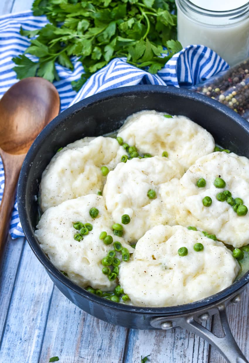 homemade peas and dumplings in a black skillet