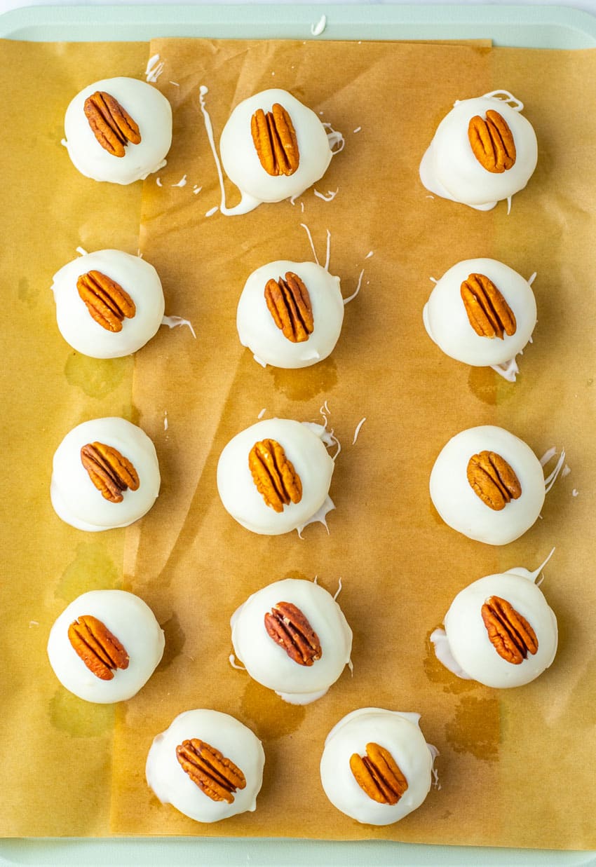 pecan pie truffles arranged in rows on a sheet of brown parchment paper