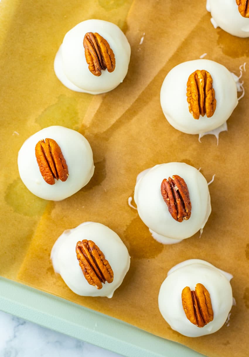 pecan pie truffles arranged in rows on a sheet of brown parchment paper