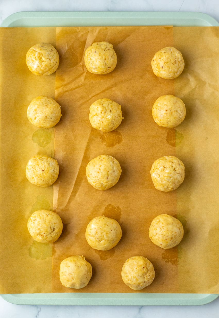 pecan pie truffles arranged in rows on a sheet of brown parchment paper