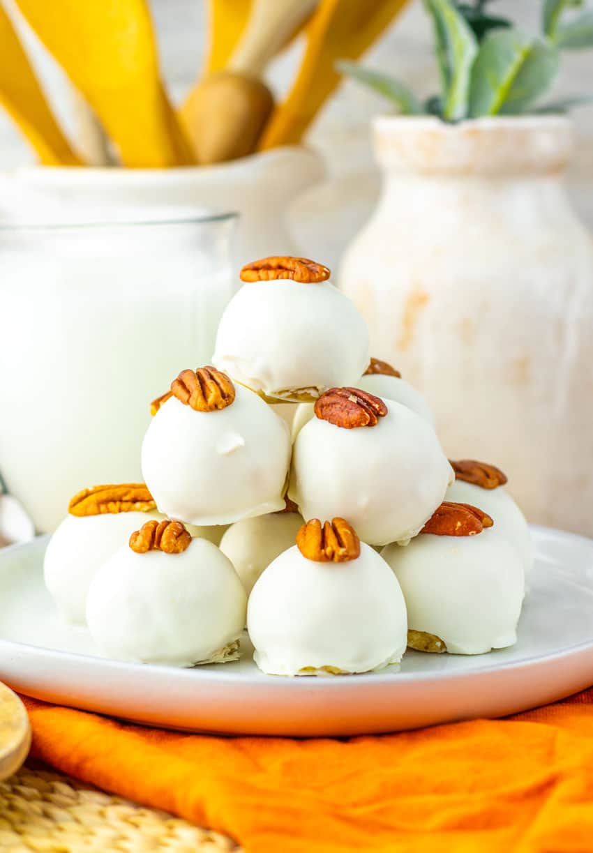 a stack of pecan pie truffles on a white plate