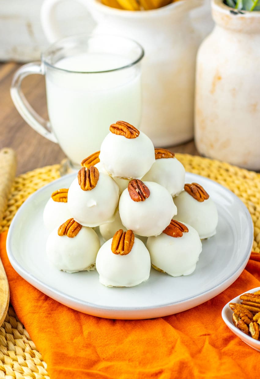 a stack of pecan pie truffles on a white plate
