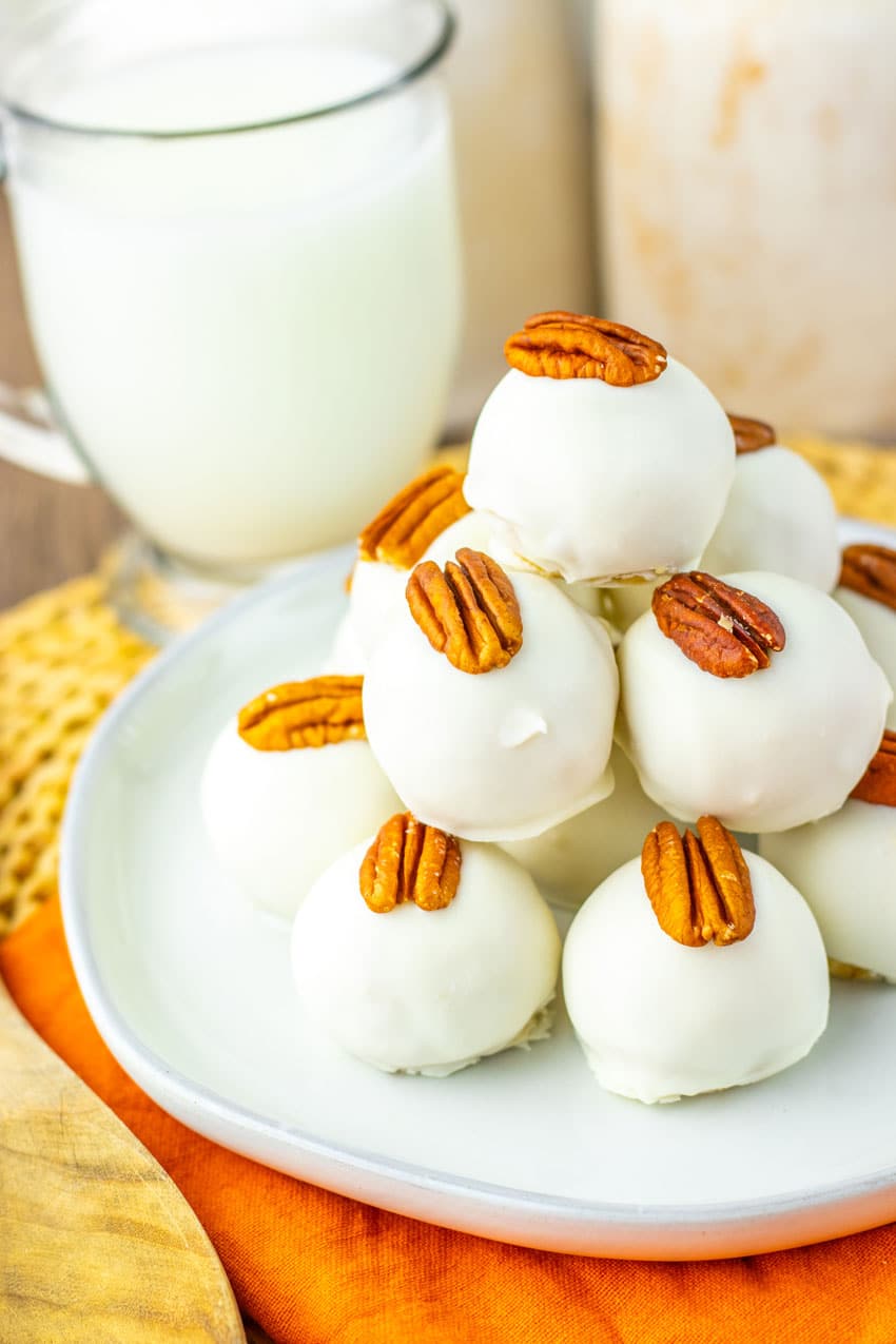 a stack of pecan pie truffles on a white plate