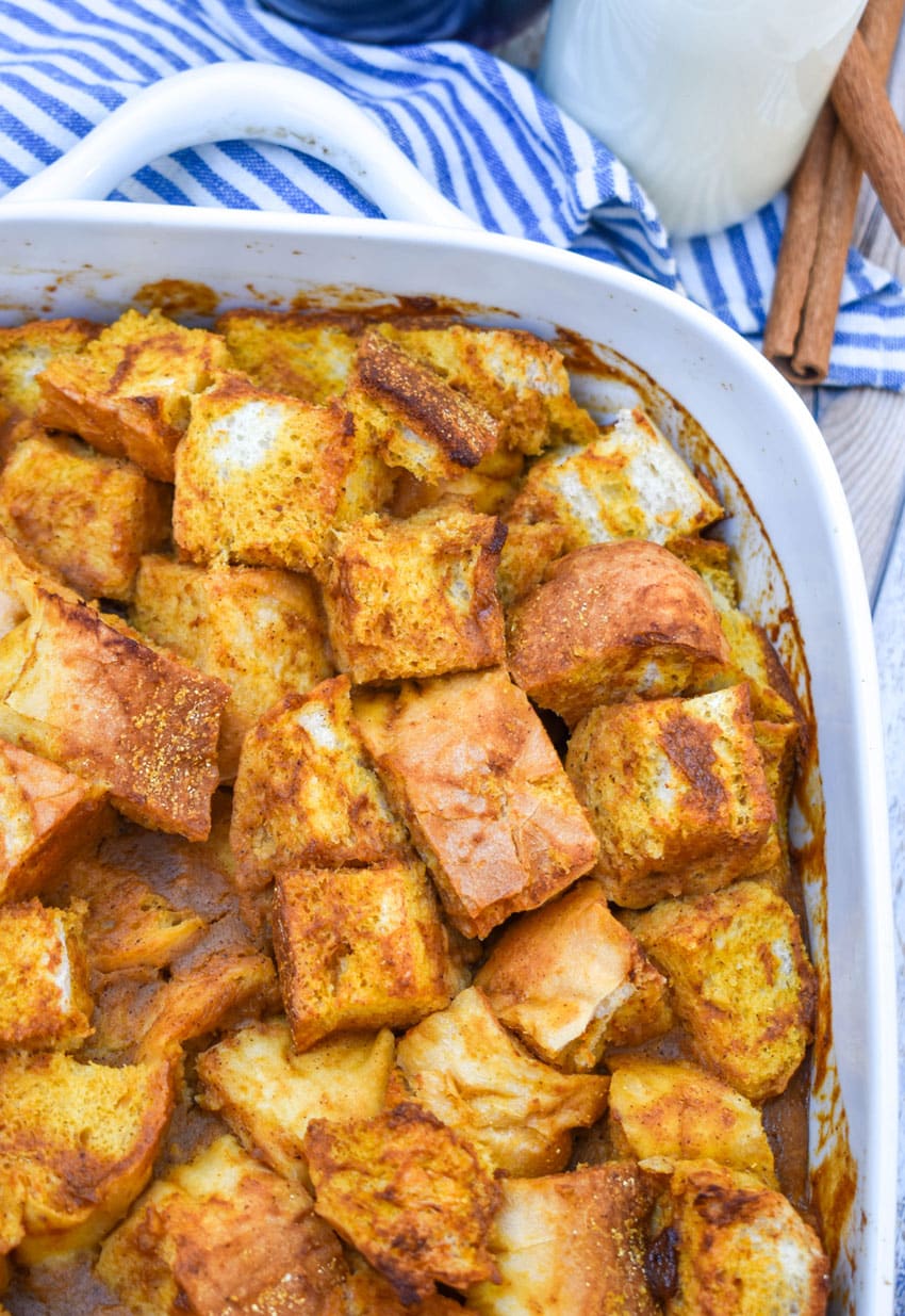 pumpkin bread pudding in a white baking dish