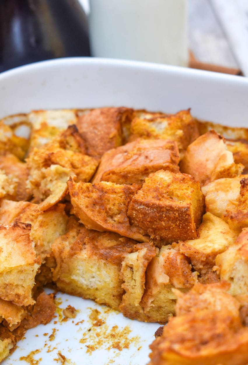 pumpkin bread pudding in a white baking dish