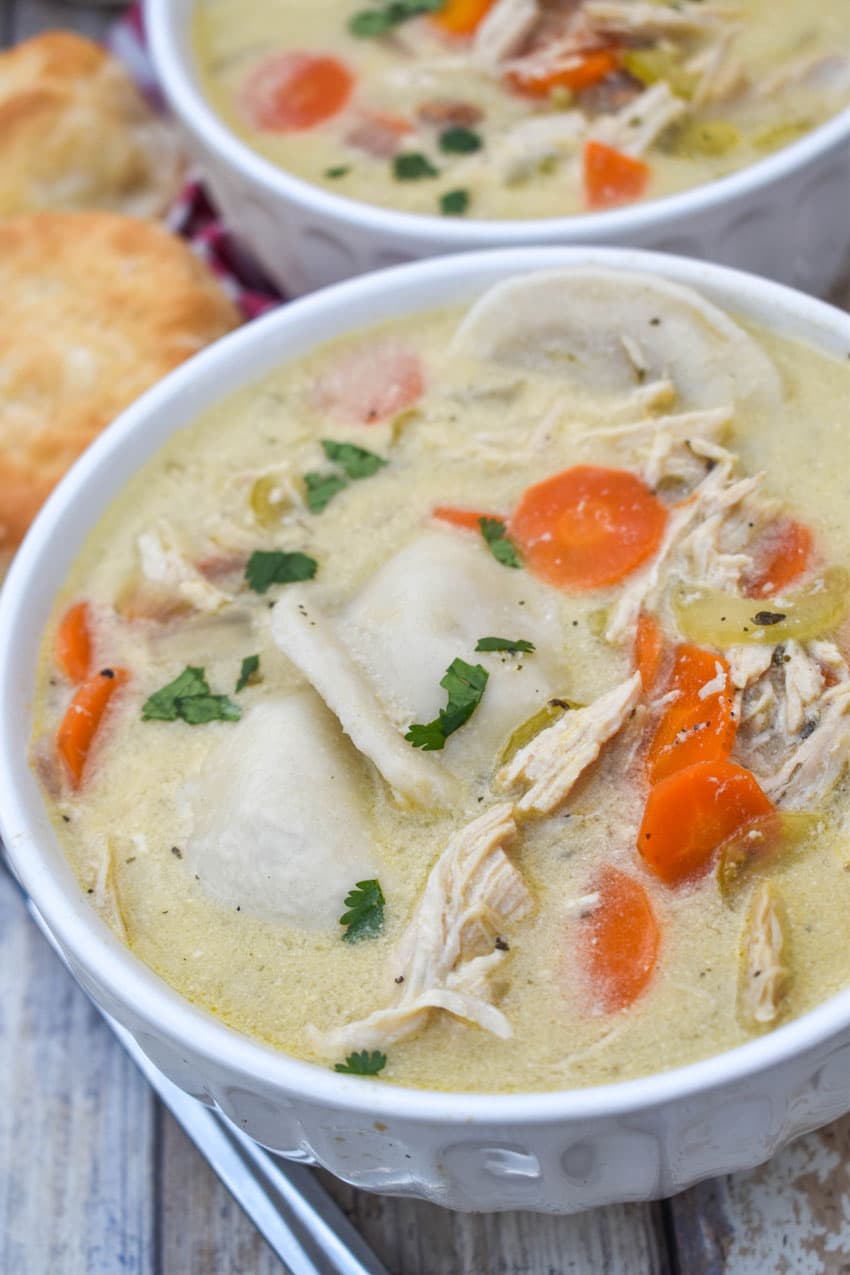 chicken and pierogi stew in two small white soup bowls