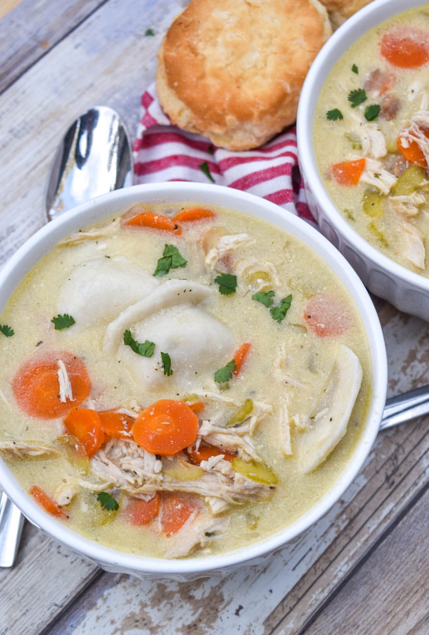 chicken and pierogi stew in two small white soup bowls
