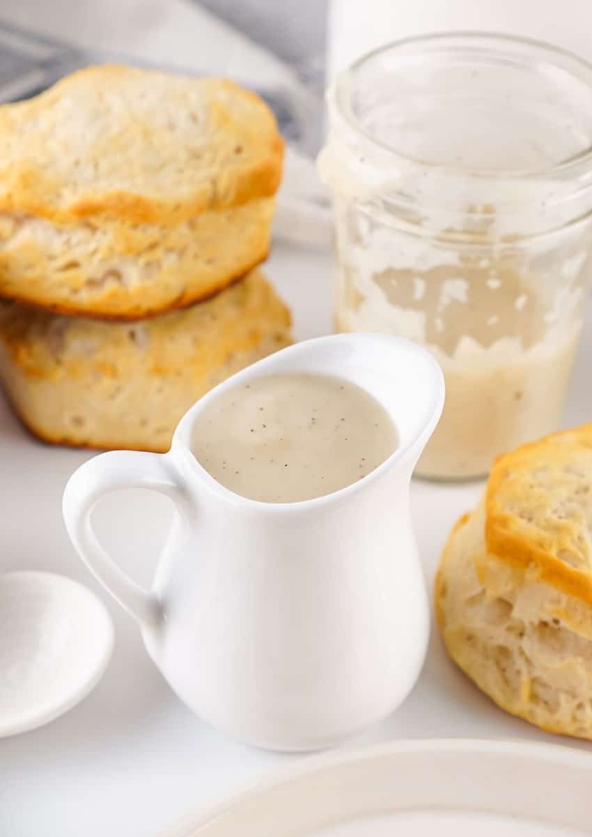 homemade white gravy in a small white pitcher