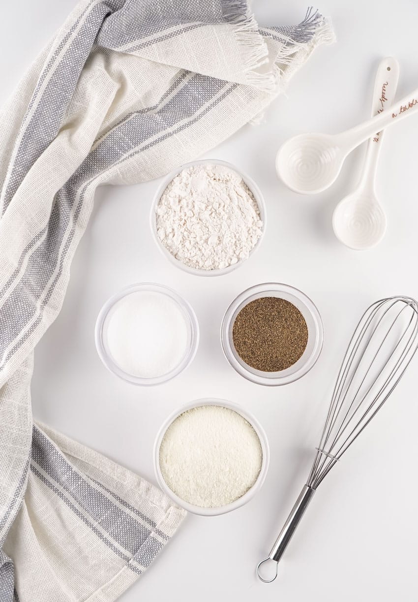 an overhead image showing the measured ingredients needed to make a batch of homemade white gravy mix