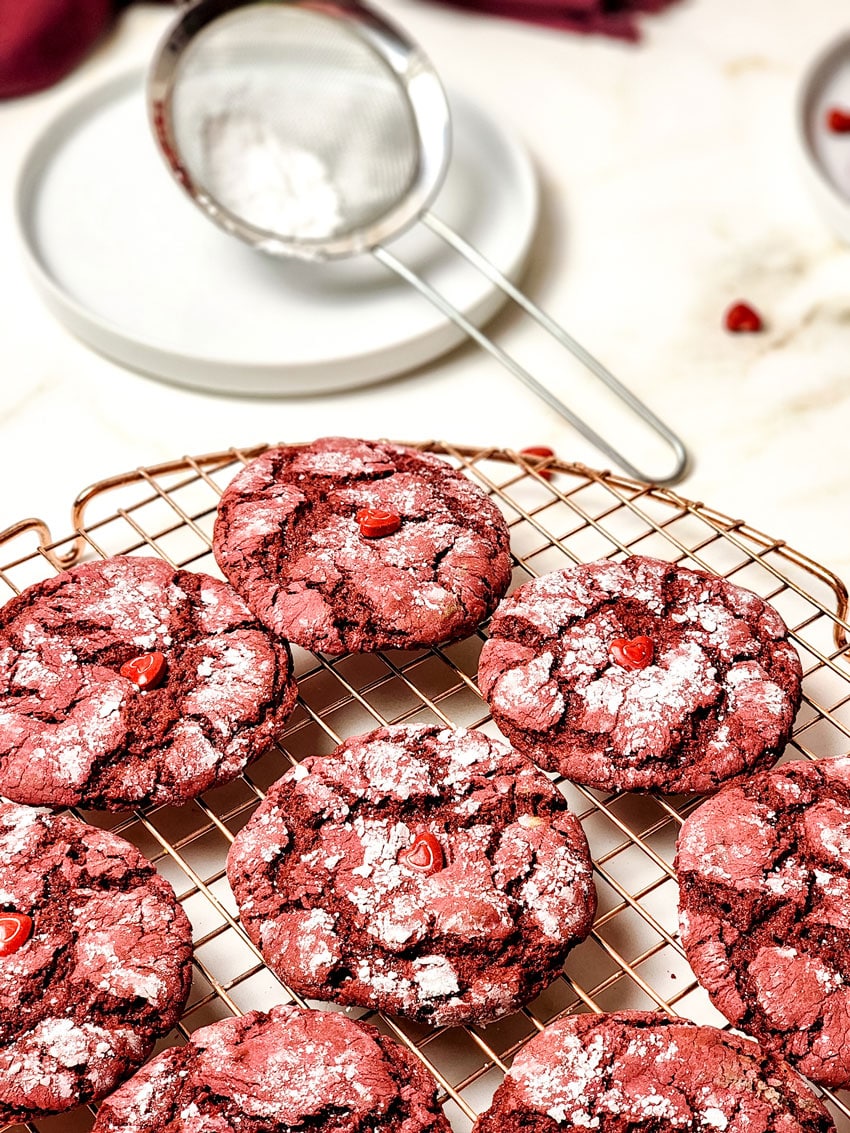red velvet crinkle cookies cooling on a wire rack