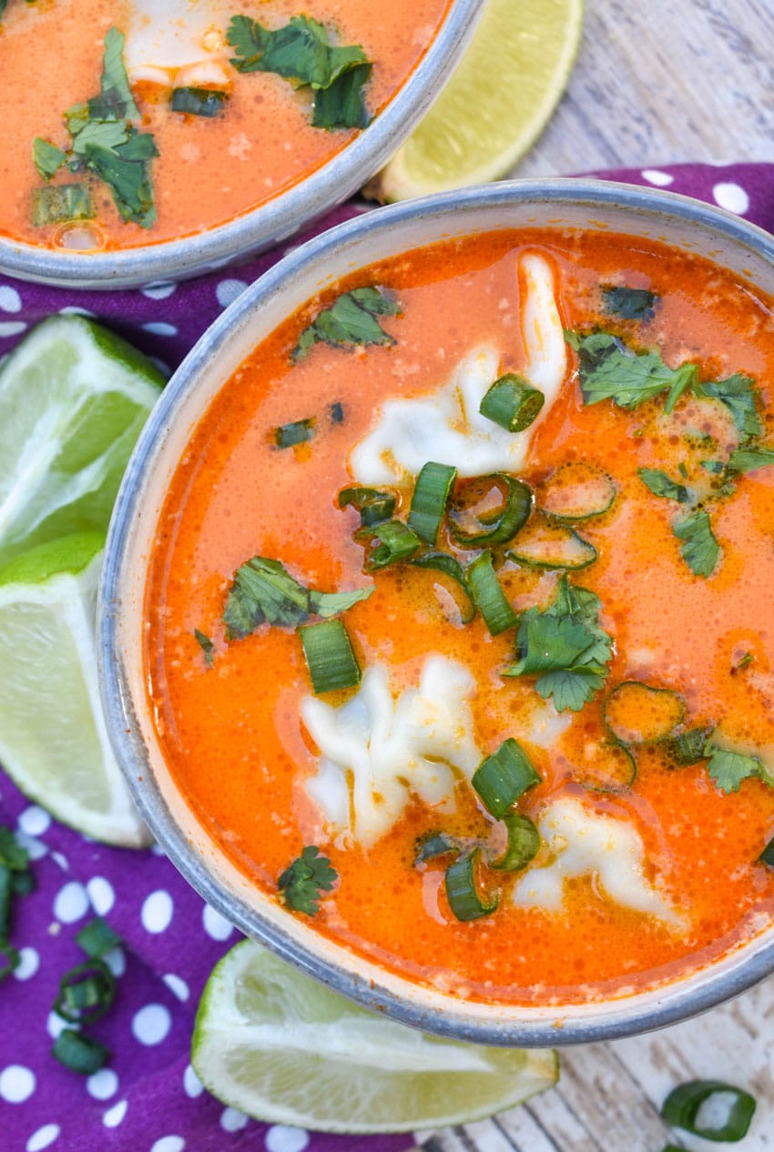coconut curry soup with wontons in two small gray bowls