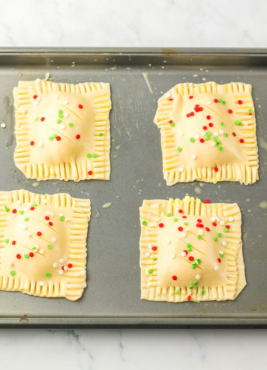 four unbaked copycat mcdonald's holiday pies on a metal baking sheet