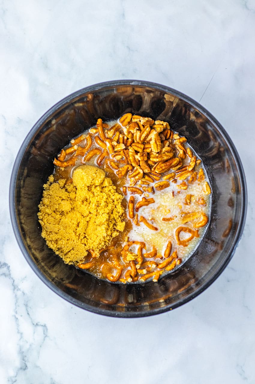 pretzel pieces, brown sugar, and butter in a metal mixing bowl