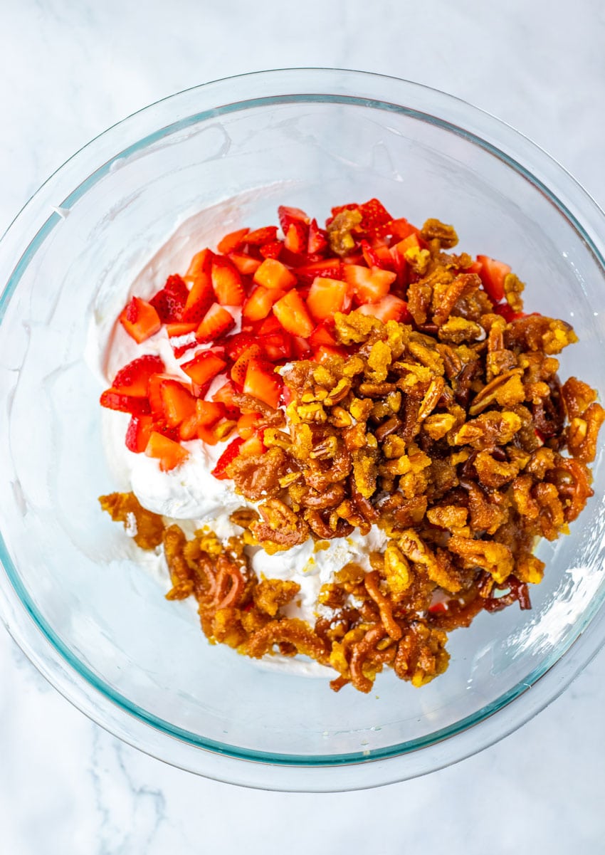 strawberry pretzel fluff salad ingredients in a large glass mixing bowl