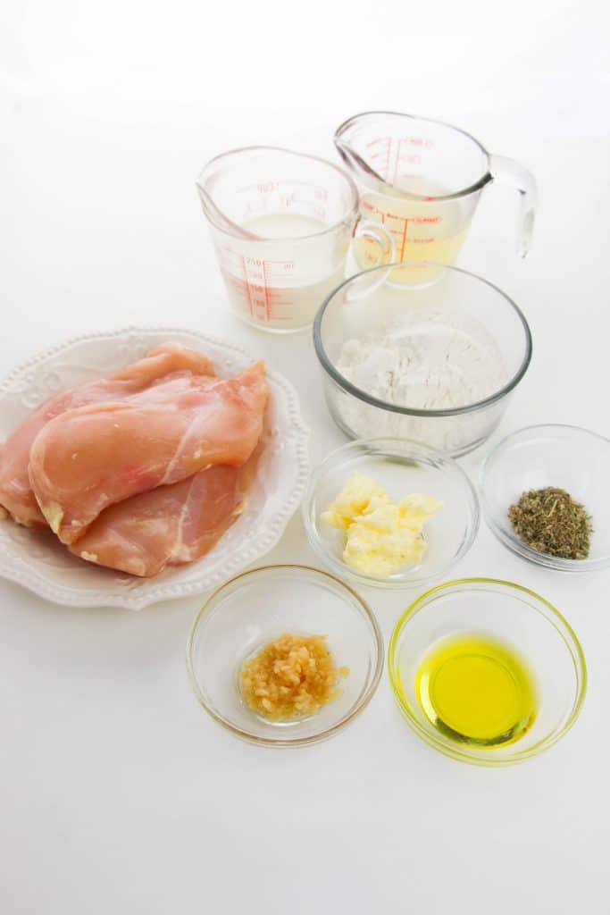 ingredients needed for making a batch of Southern smothered chicken in a skillet