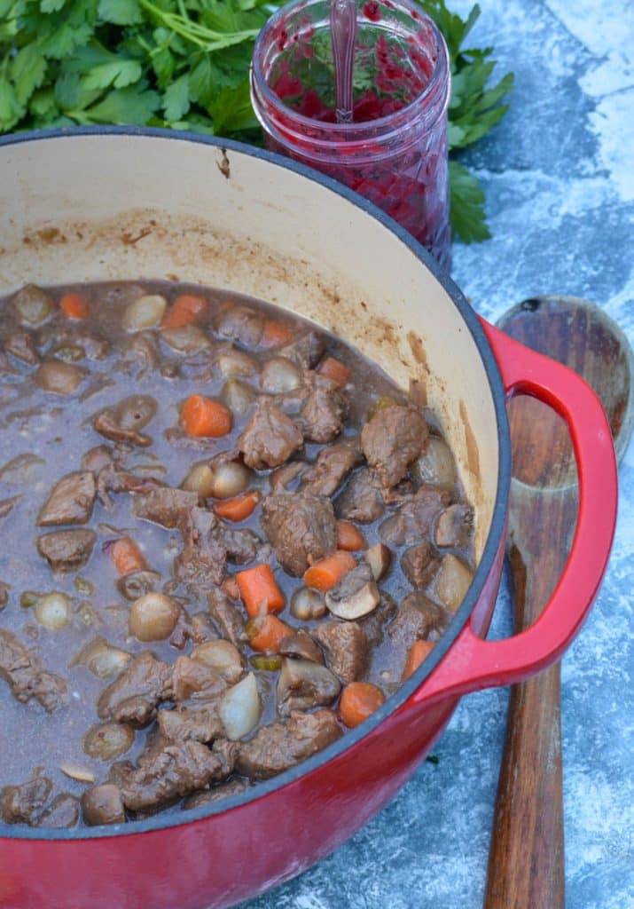 cranberry beef stew in a large red enameled dutch oven