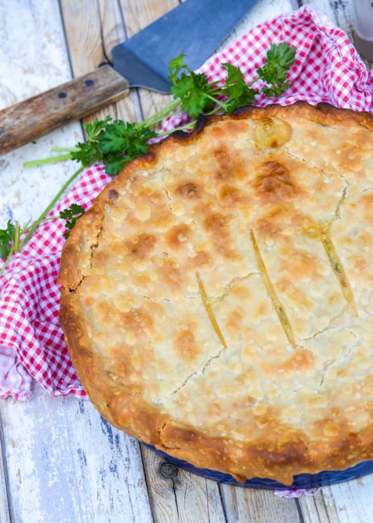 shortcut chicken pot pie with a golden brown crust on a wooden table