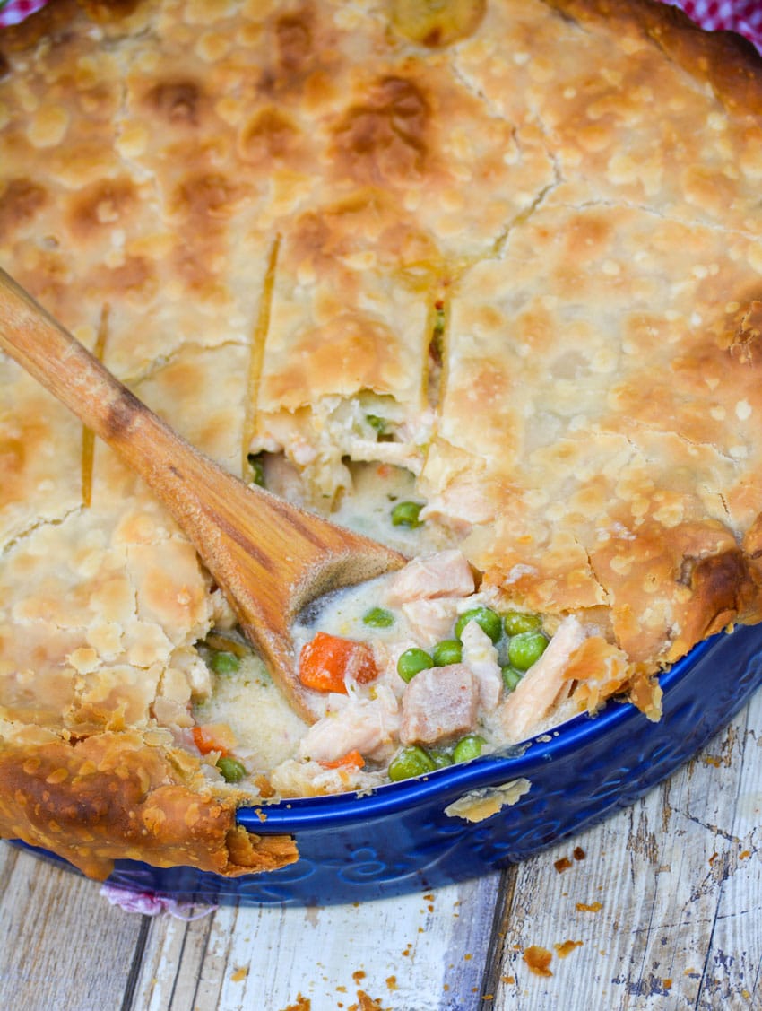 Shortcut Chicken Pot Pie a wooden spoon scooping out the creamy center of shortcut chicken pot pie