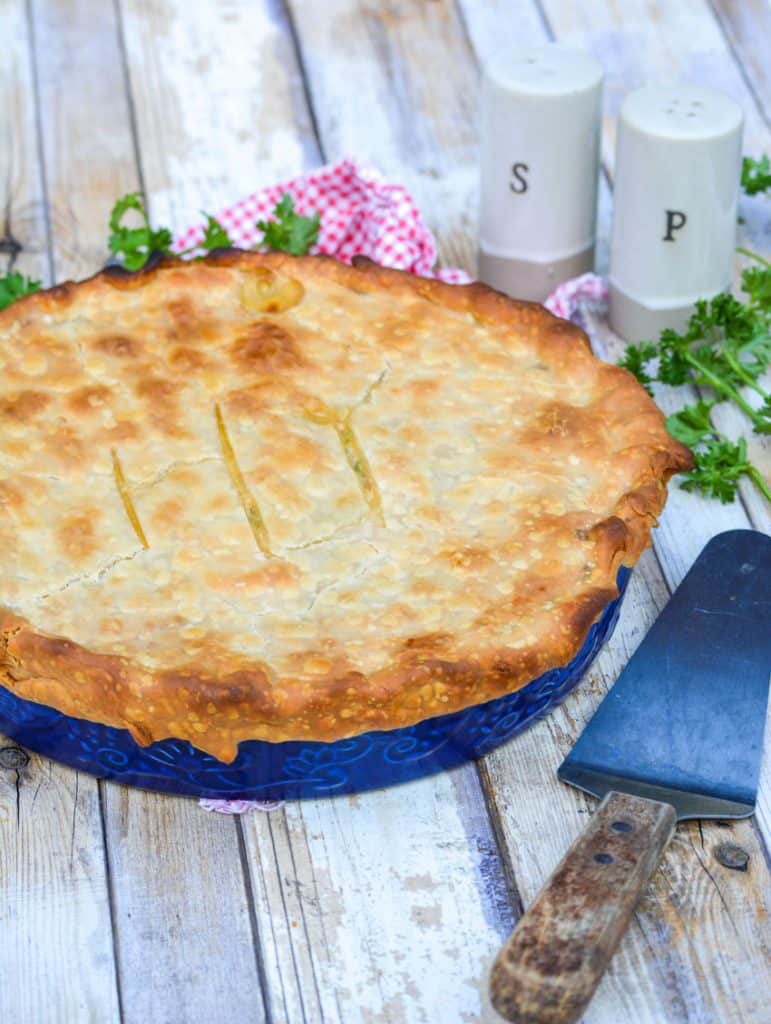 shortcut chicken pot pie with a golden brown crust on a wooden table