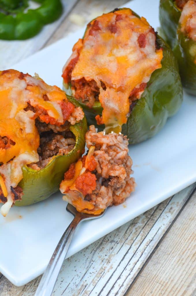 a silver fork full of ground beef and rice stuffed pepper filling
