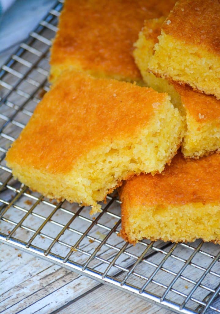 a slice of golden cornbread with a bite taken out of one corner
